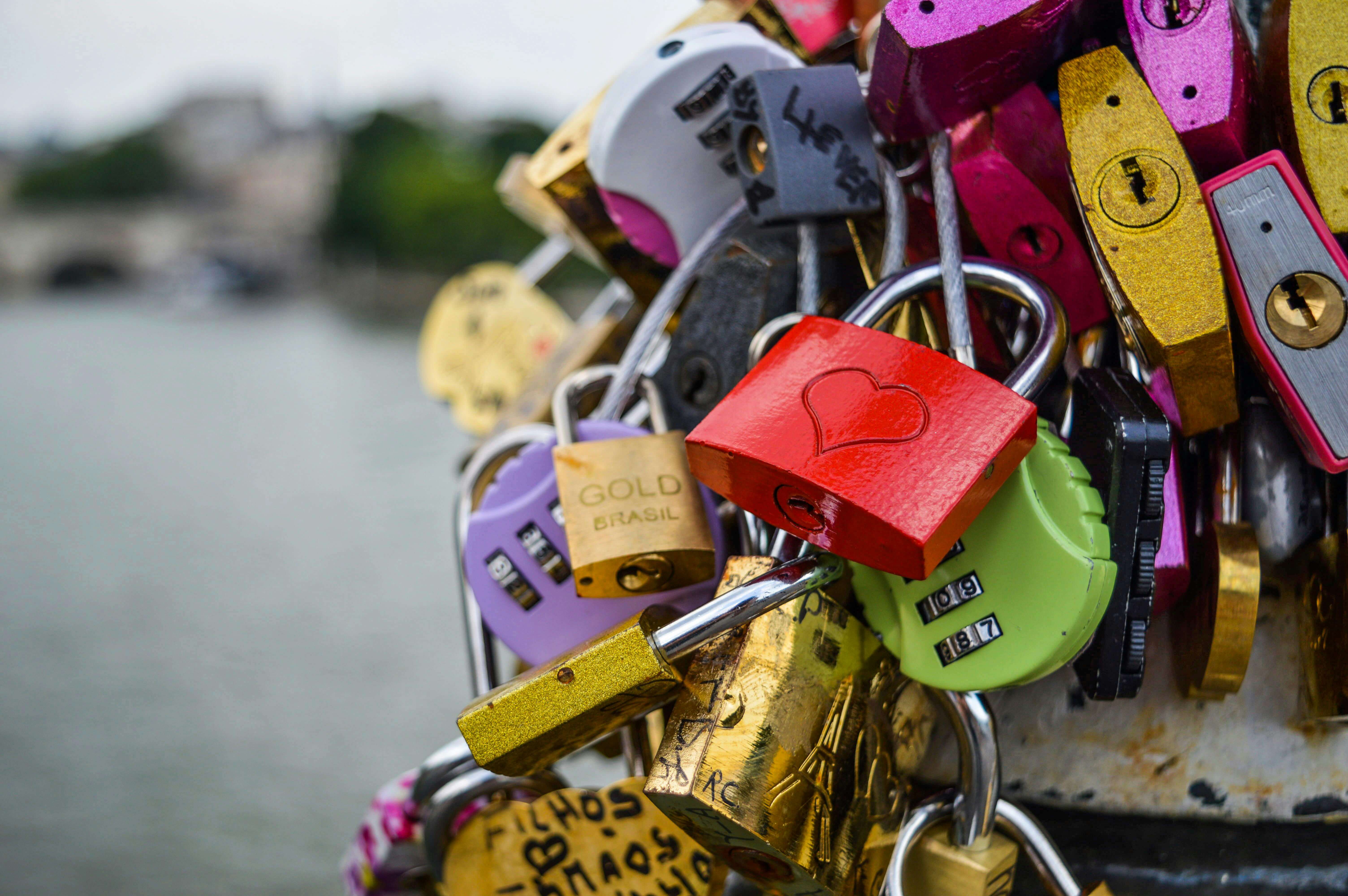 Vibrant love locks attached to a bridge in Paris symbolizing romance and commitment.