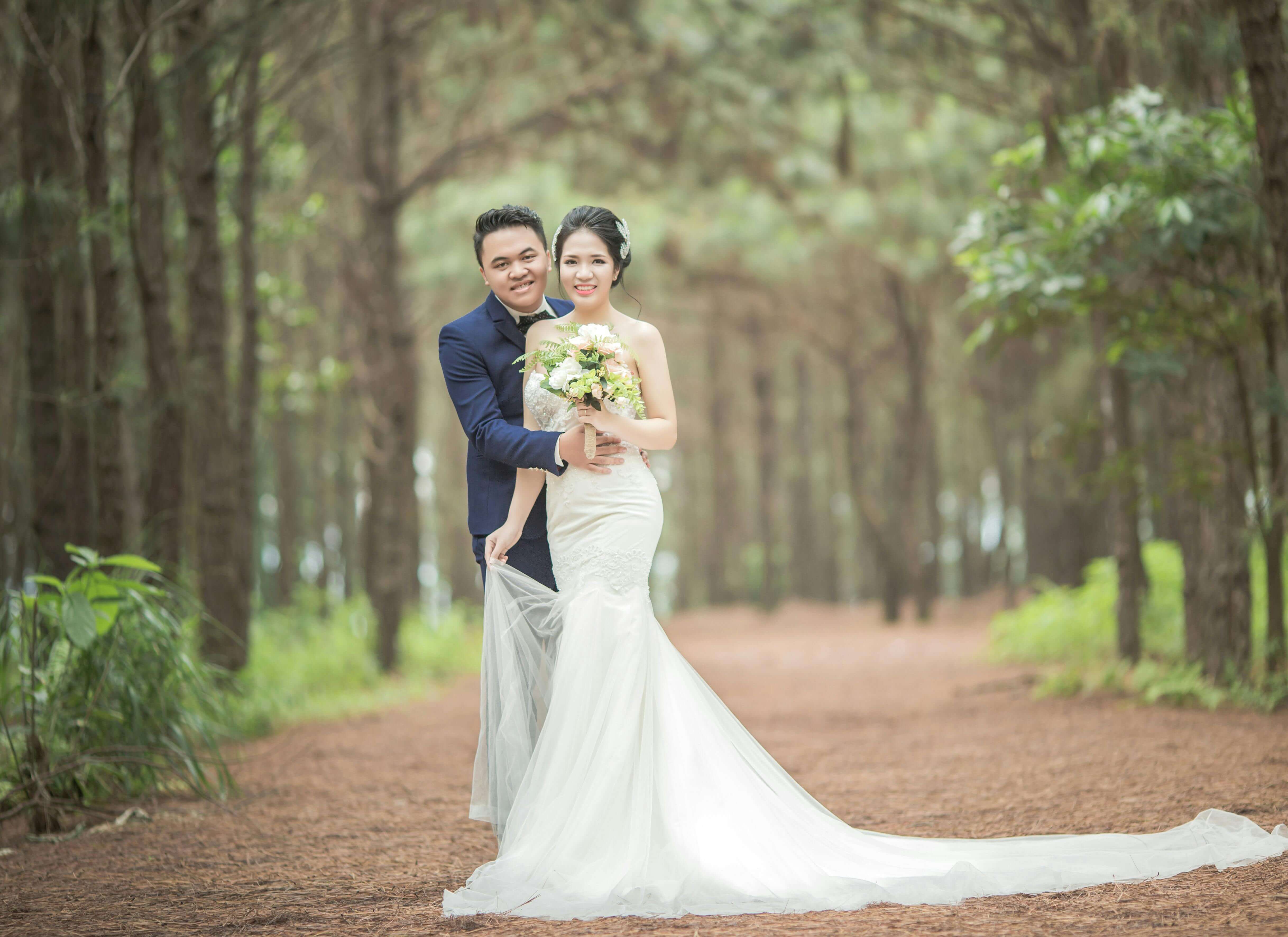 Romantic wedding couple posing in forest, capturing love and happiness.