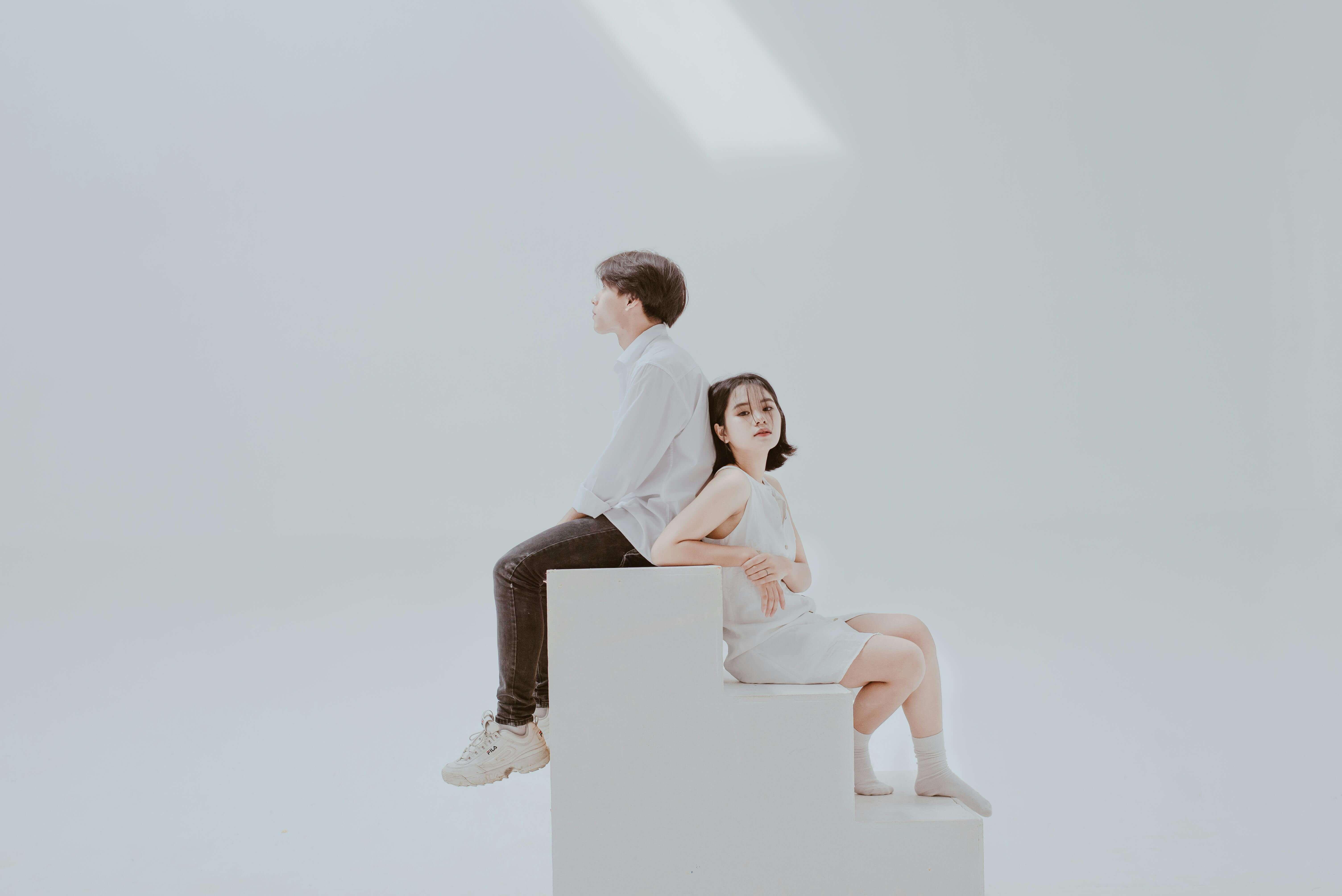 A serene minimalist portrait of a young couple in a Hanoi studio, symbolizing connection and harmony.