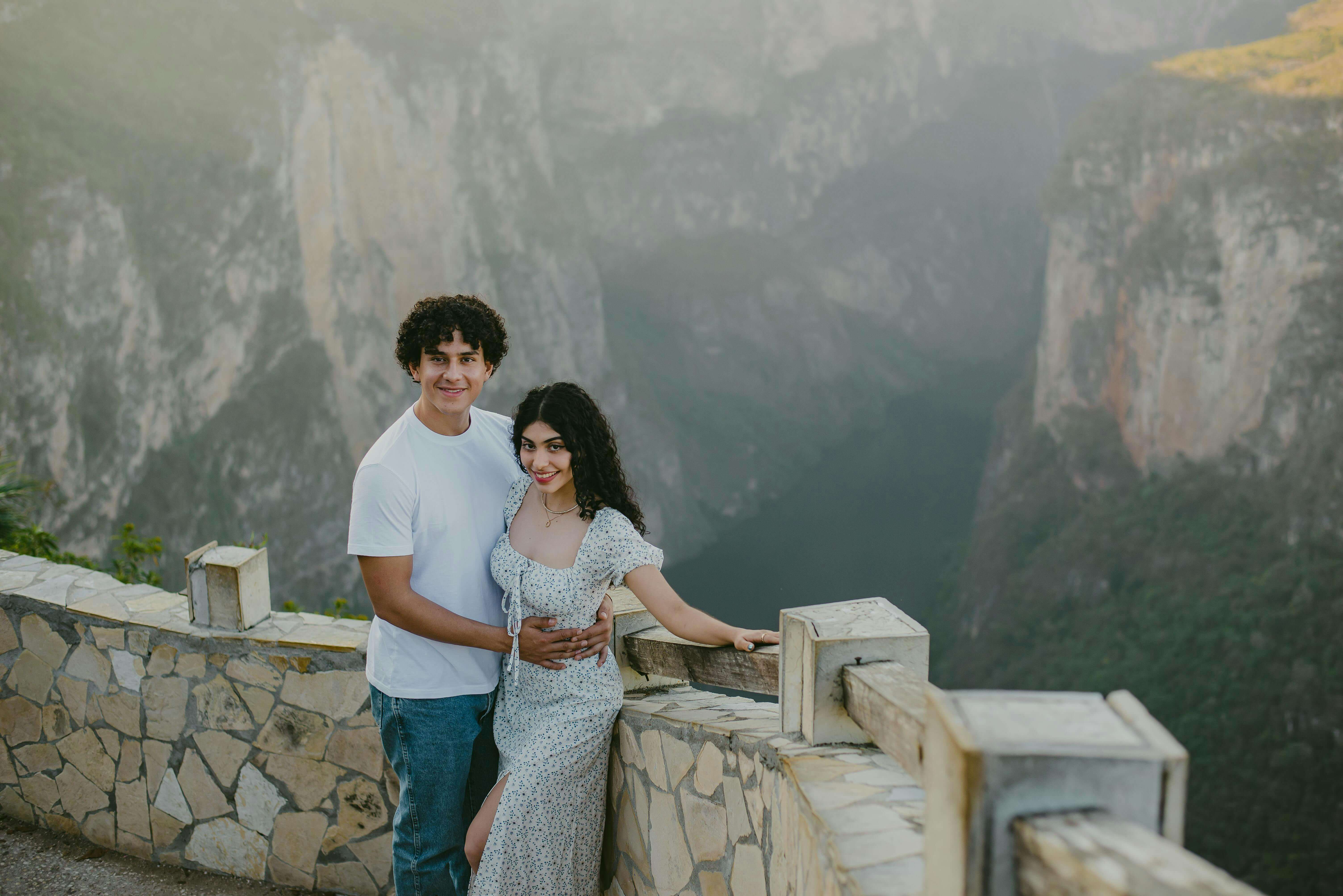 A joyful couple embracing at a scenic canyon viewpoint, capturing their happiness.