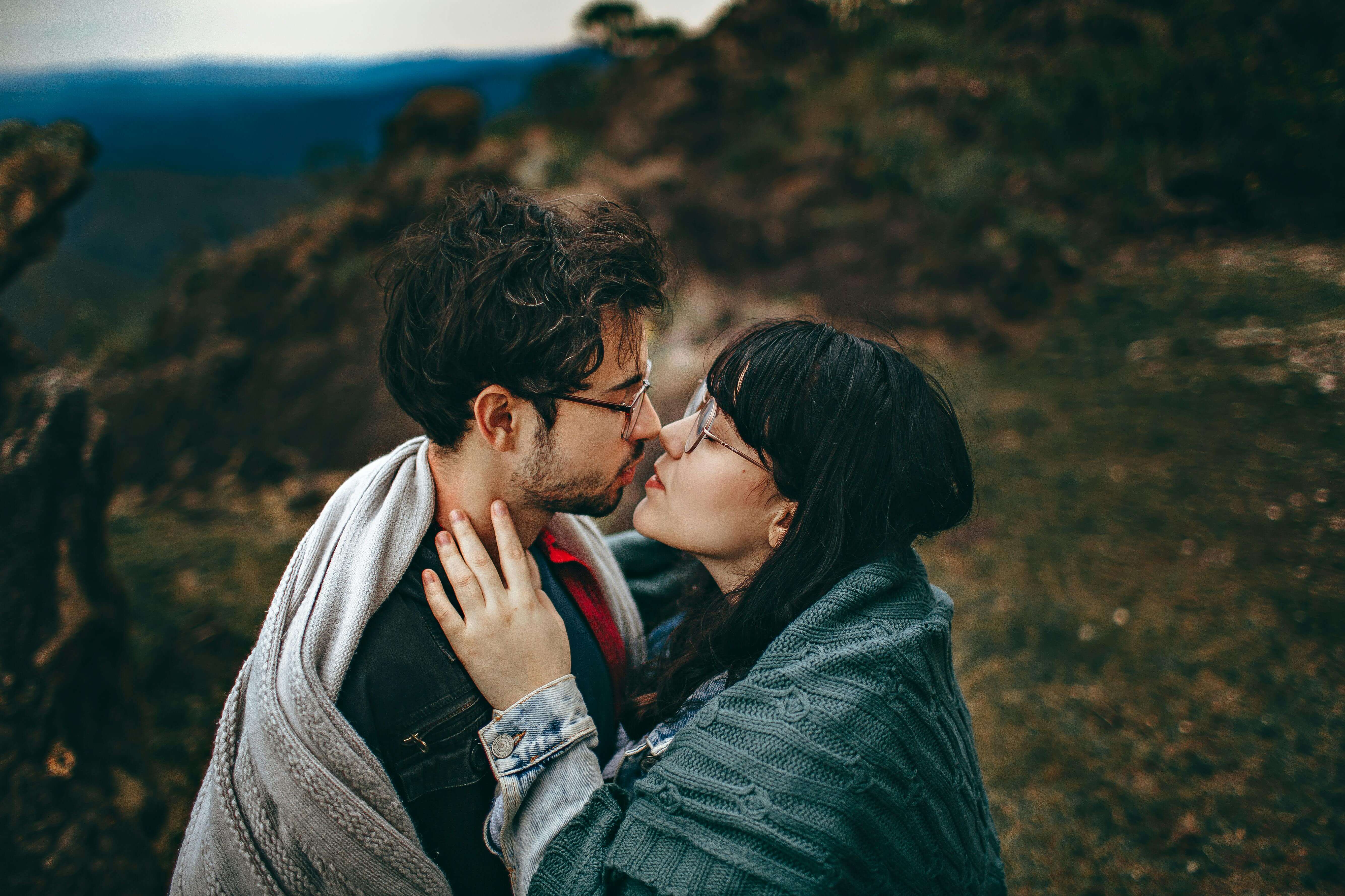 Young couple sharing an intimate embrace in a scenic outdoor setting in Brazil, showcasing love and romance.