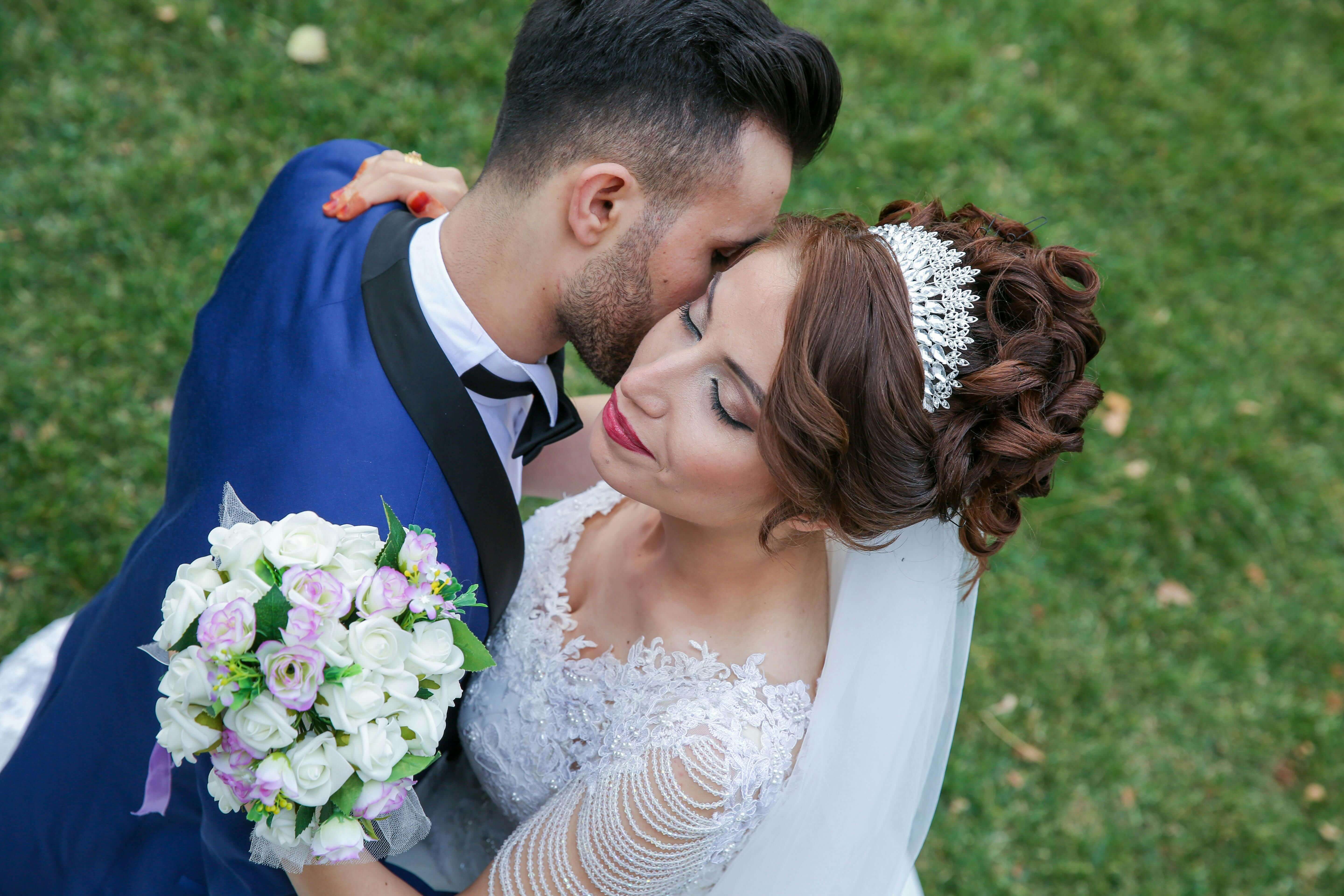 Beautiful outdoor wedding scene with couple embracing, showcasing love and togetherness.