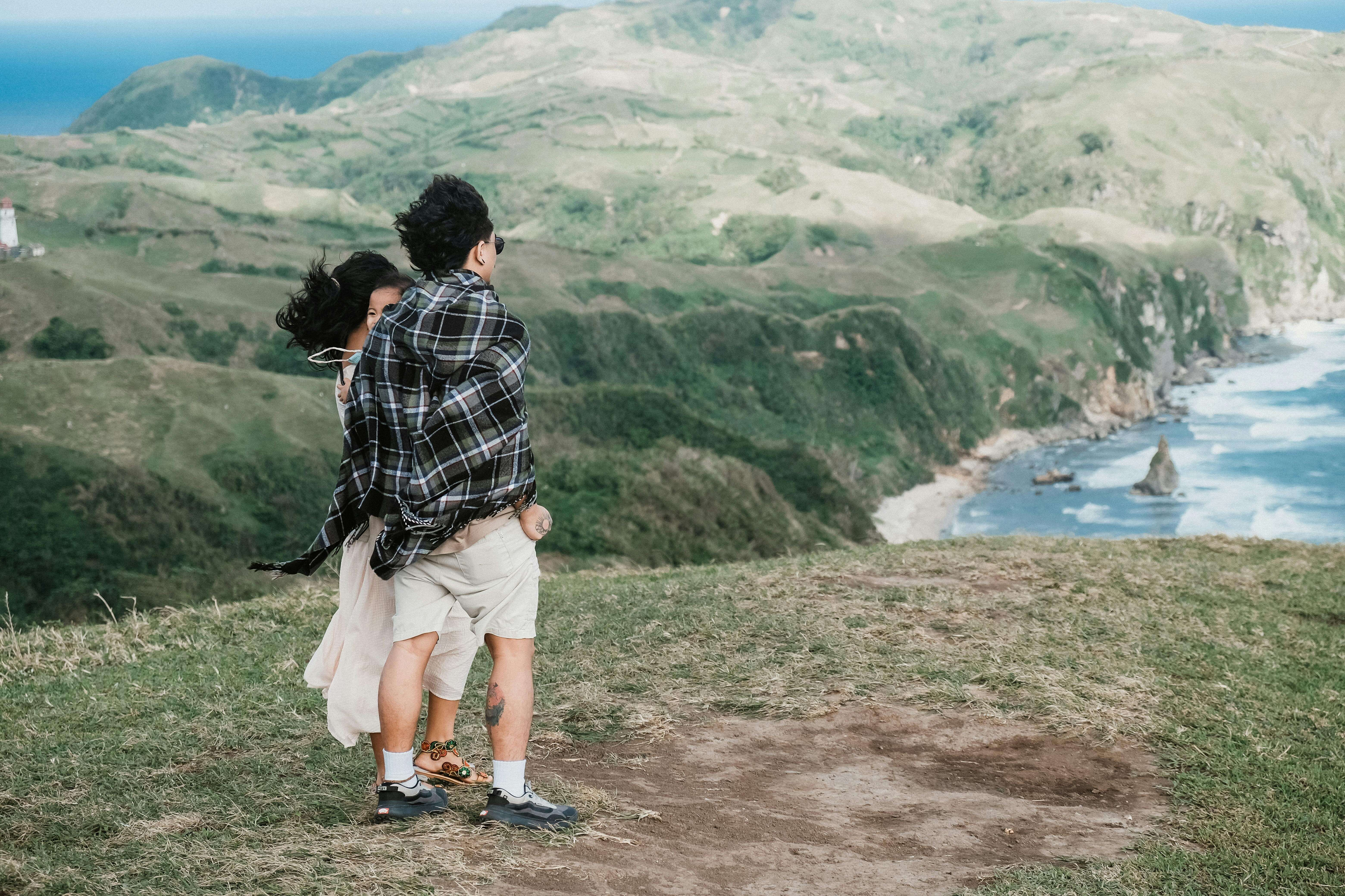 A couple embraces while overlooking the stunning coastal landscape of Cagayan Valley, Philippines.