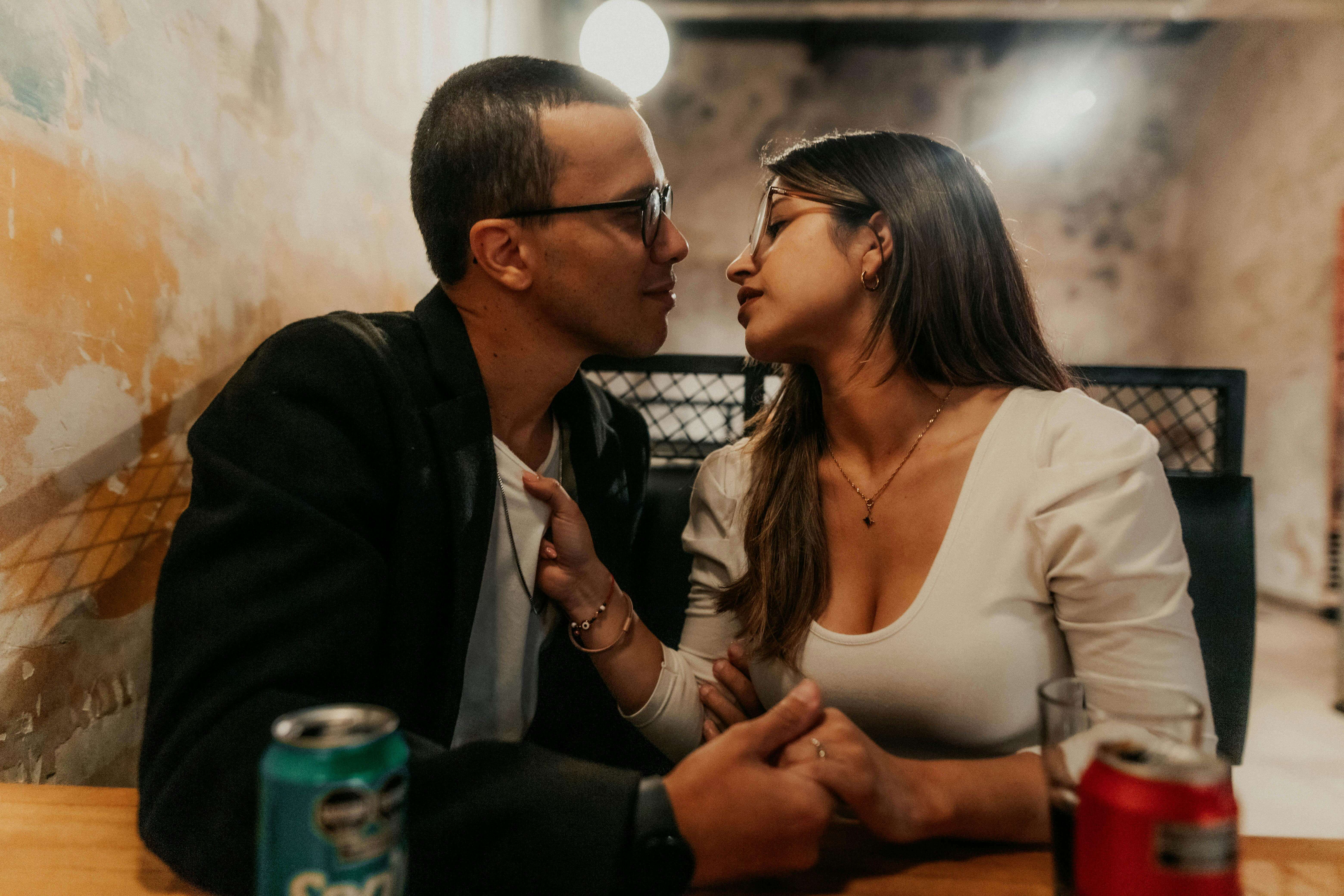 A couple sharing an intimate moment in a cozy Buenos Aires cafe, capturing love.