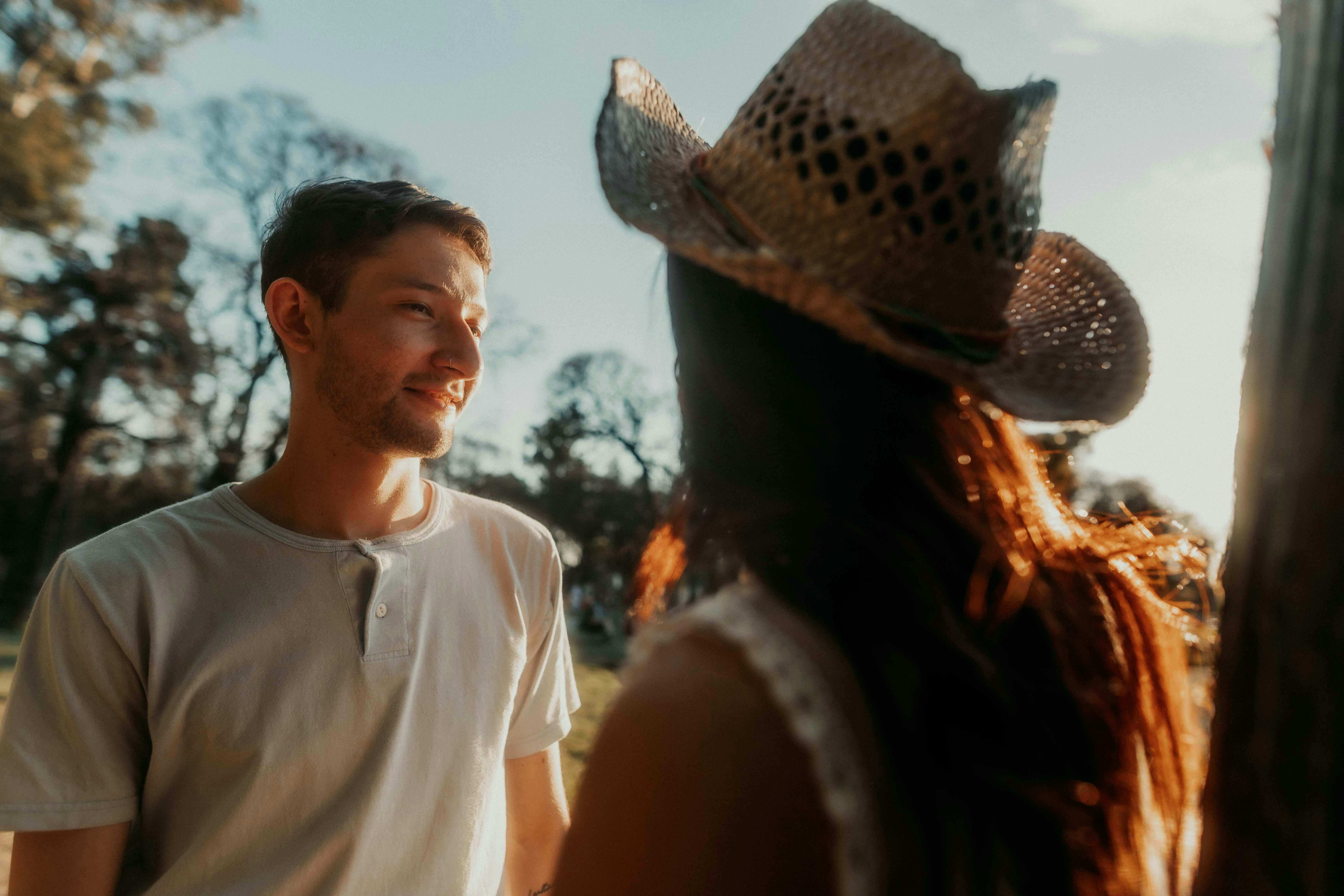 A couple enjoying a warm, romantic moment in Buenos Aires park during sunset.