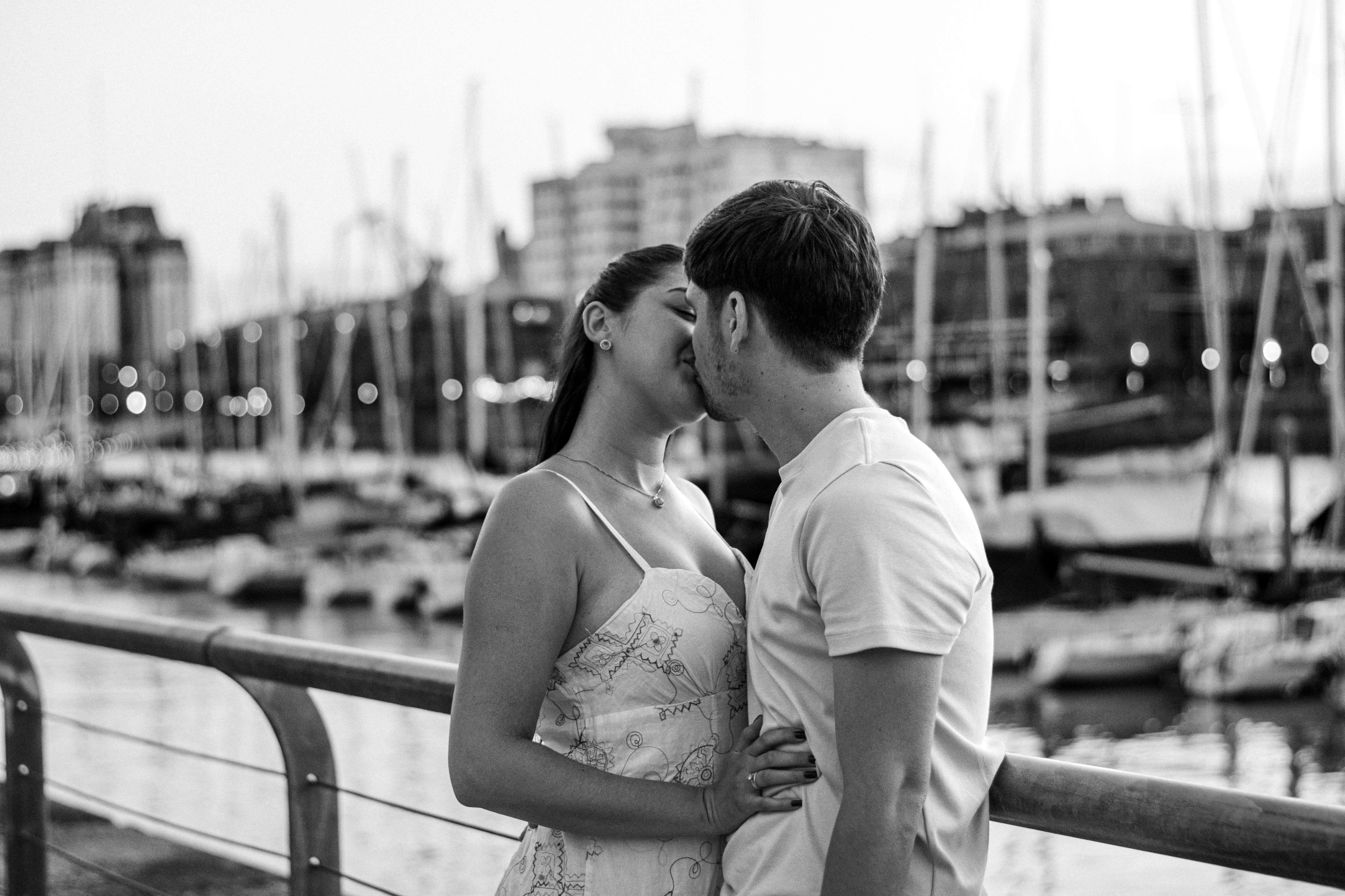 A couple sharing a romantic kiss at the marina in Buenos Aires, Argentina.