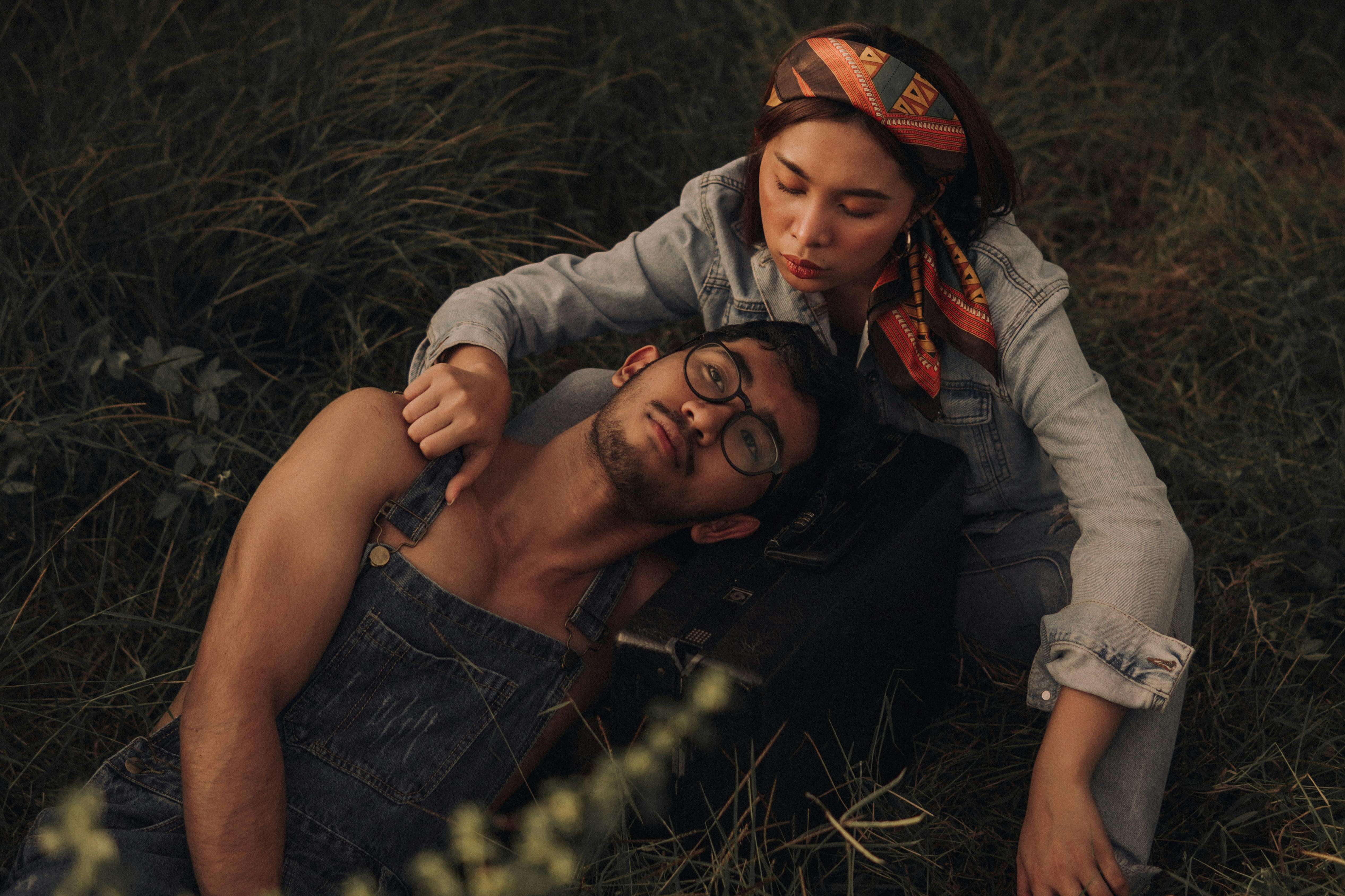 A couple sharing a tender moment outdoors, embodying romance and leisure in a fall setting.