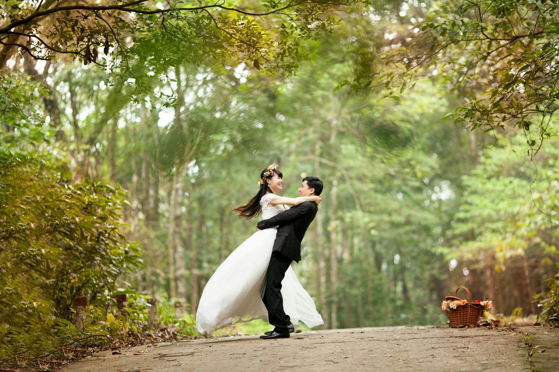 Charming couple poses in beautiful forest, celebrating their love in an enchanting outdoor wedding ceremony.