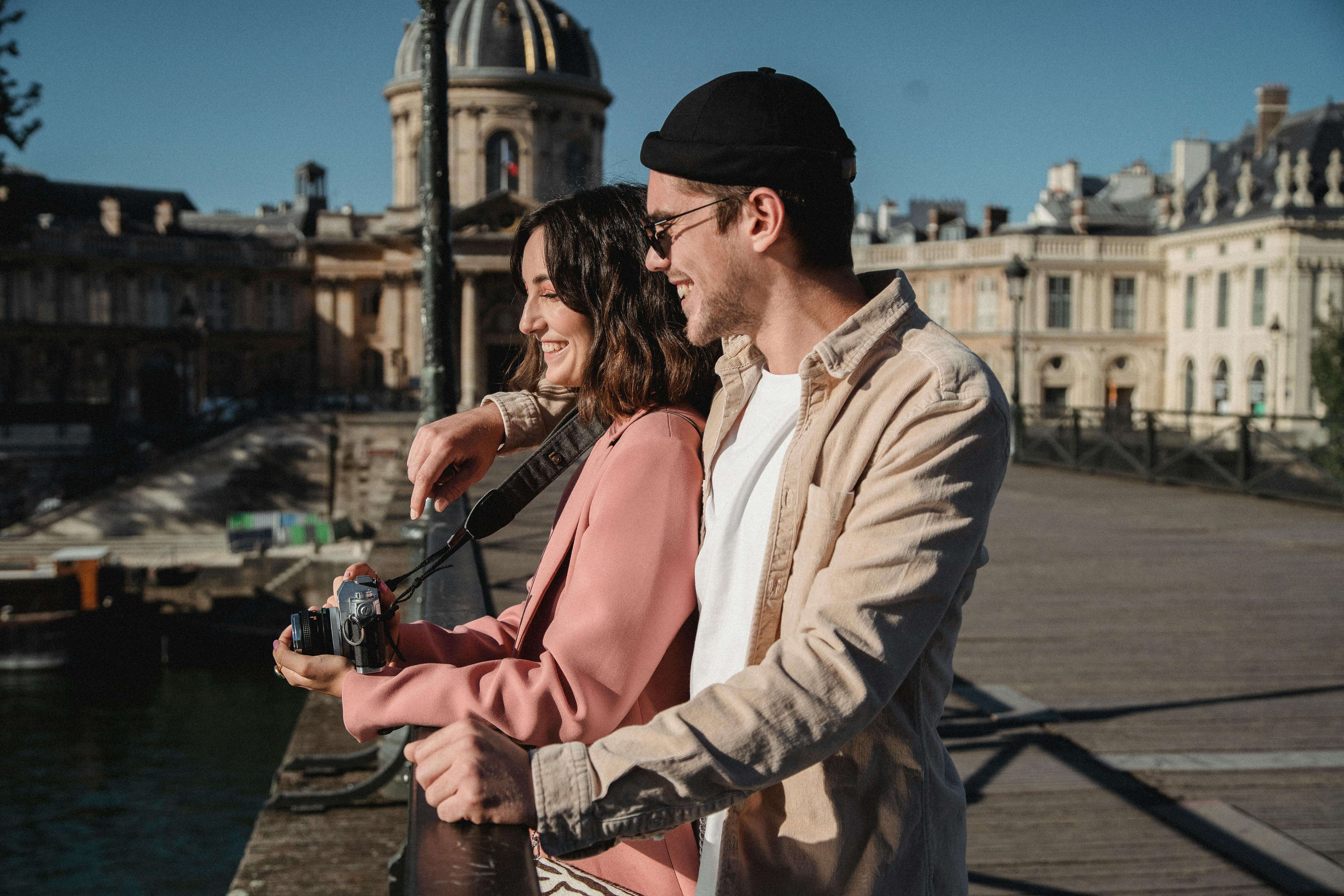 A couple on a romantic walk with a camera in beautiful Paris. Capturing love and joy.