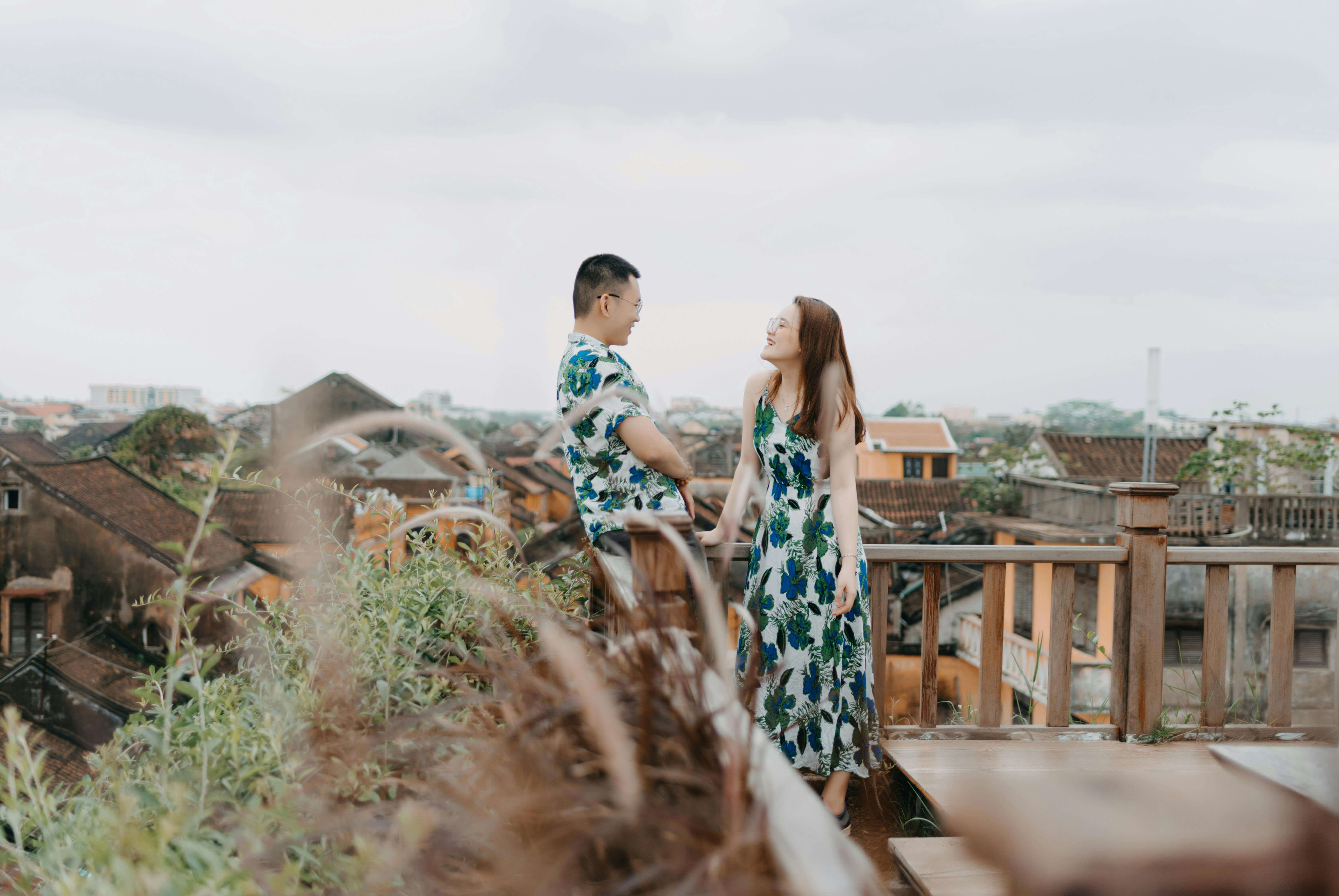Young couple enjoying a romantic moment on a scenic rooftop terrace overlooking the town.