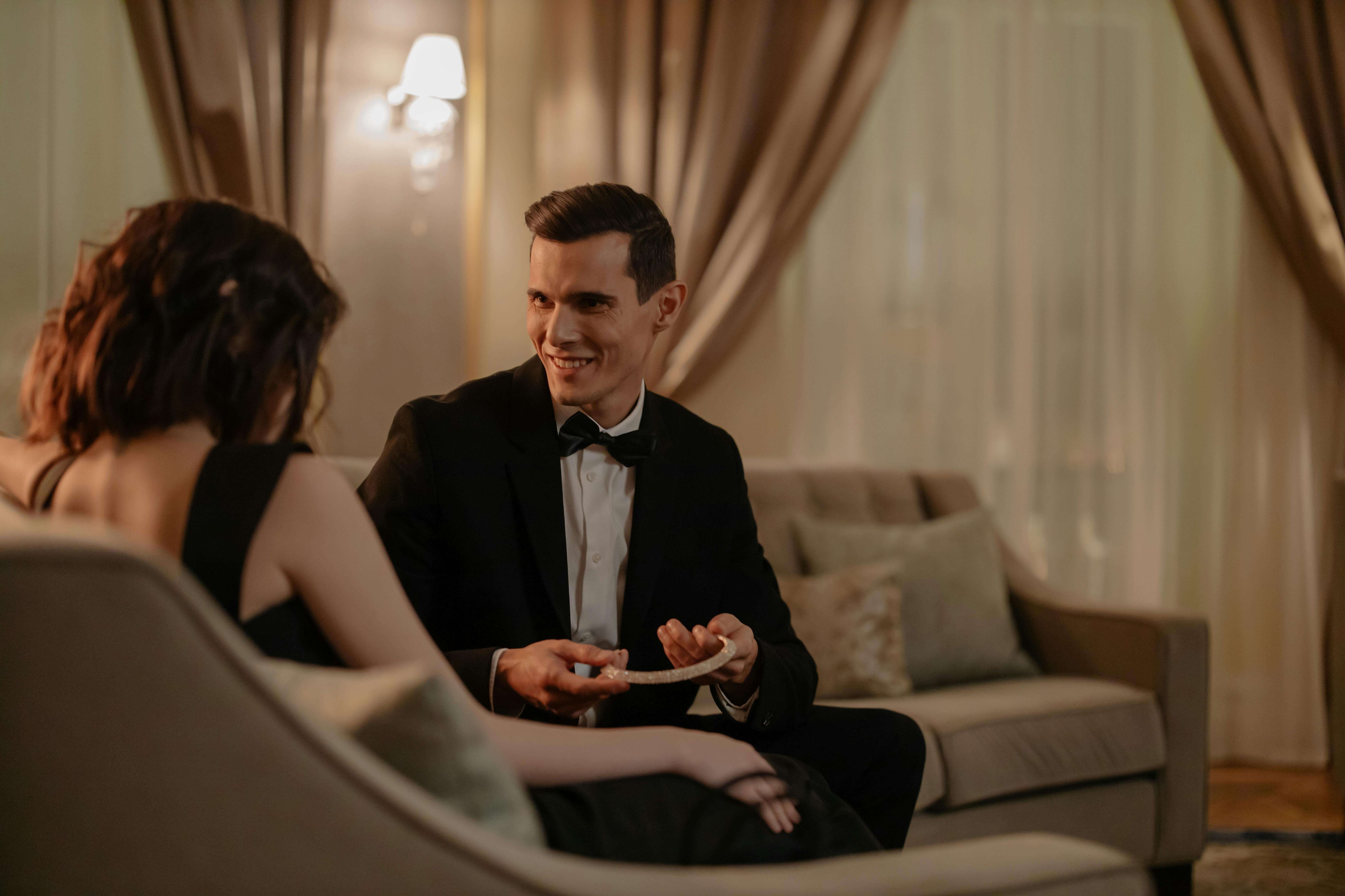 A couple in formal attire sharing a romantic moment indoors, perfect for Valentines Day.