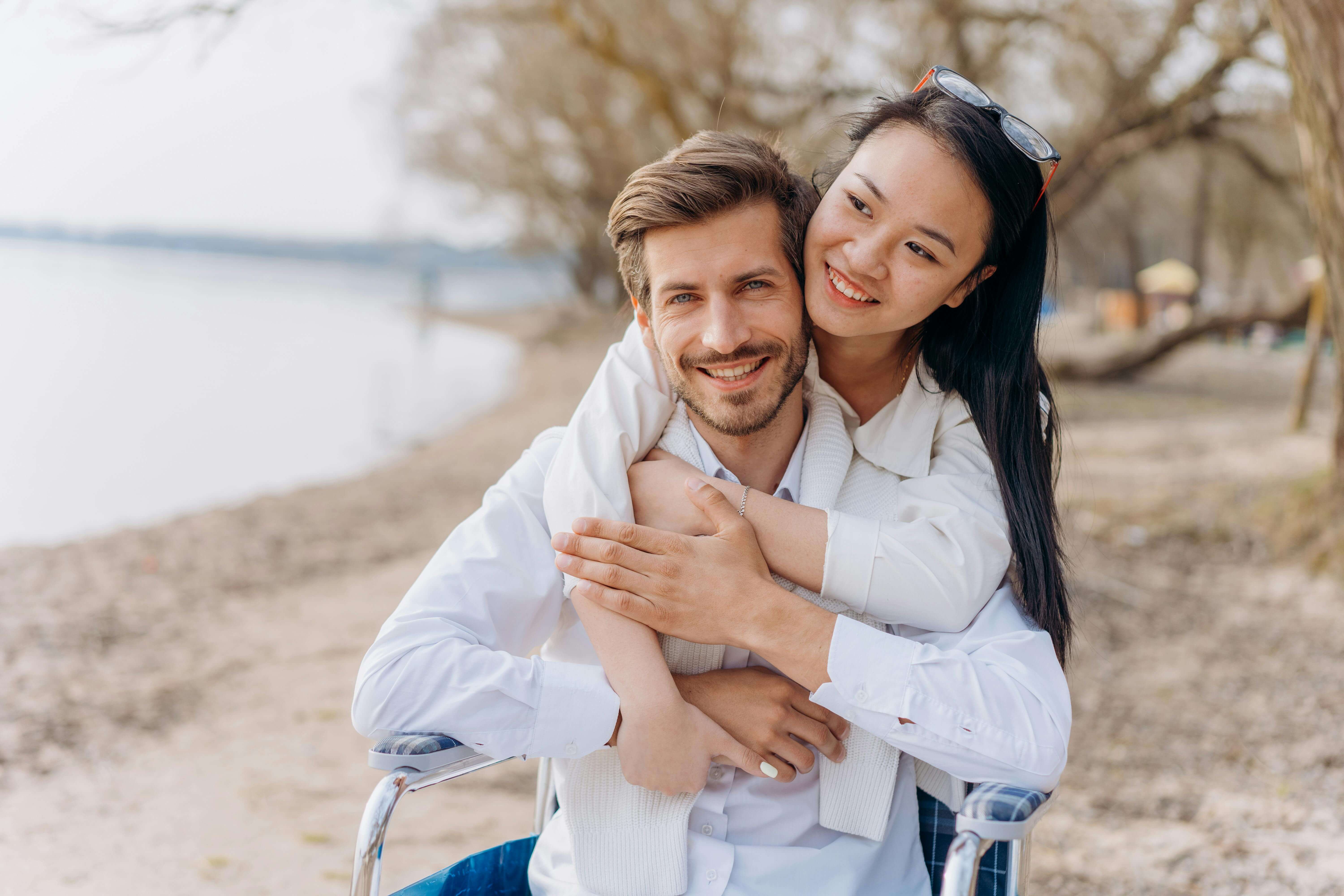 Happy couple embracing on a seaside, highlighting love and togetherness at the beach.