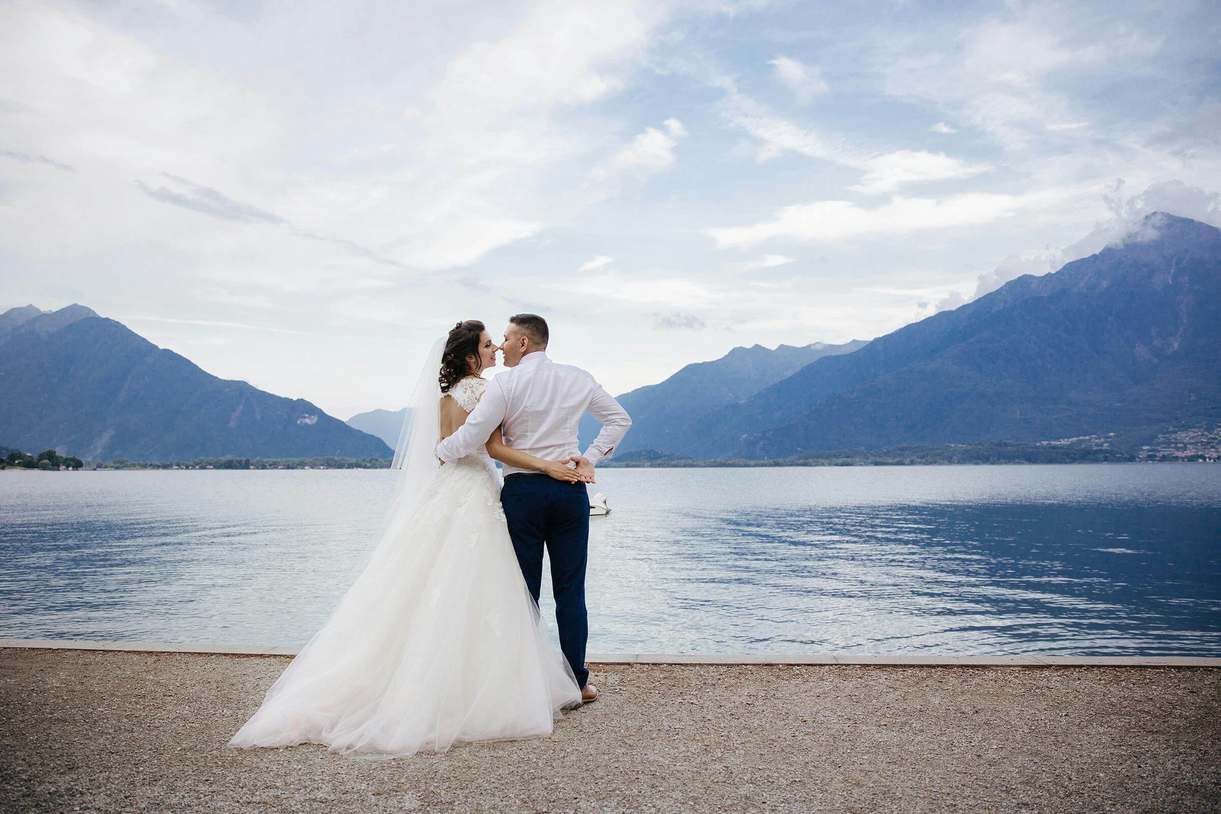 Bride and groom share a romantic moment by Lake Como in Menaggio, Italy.