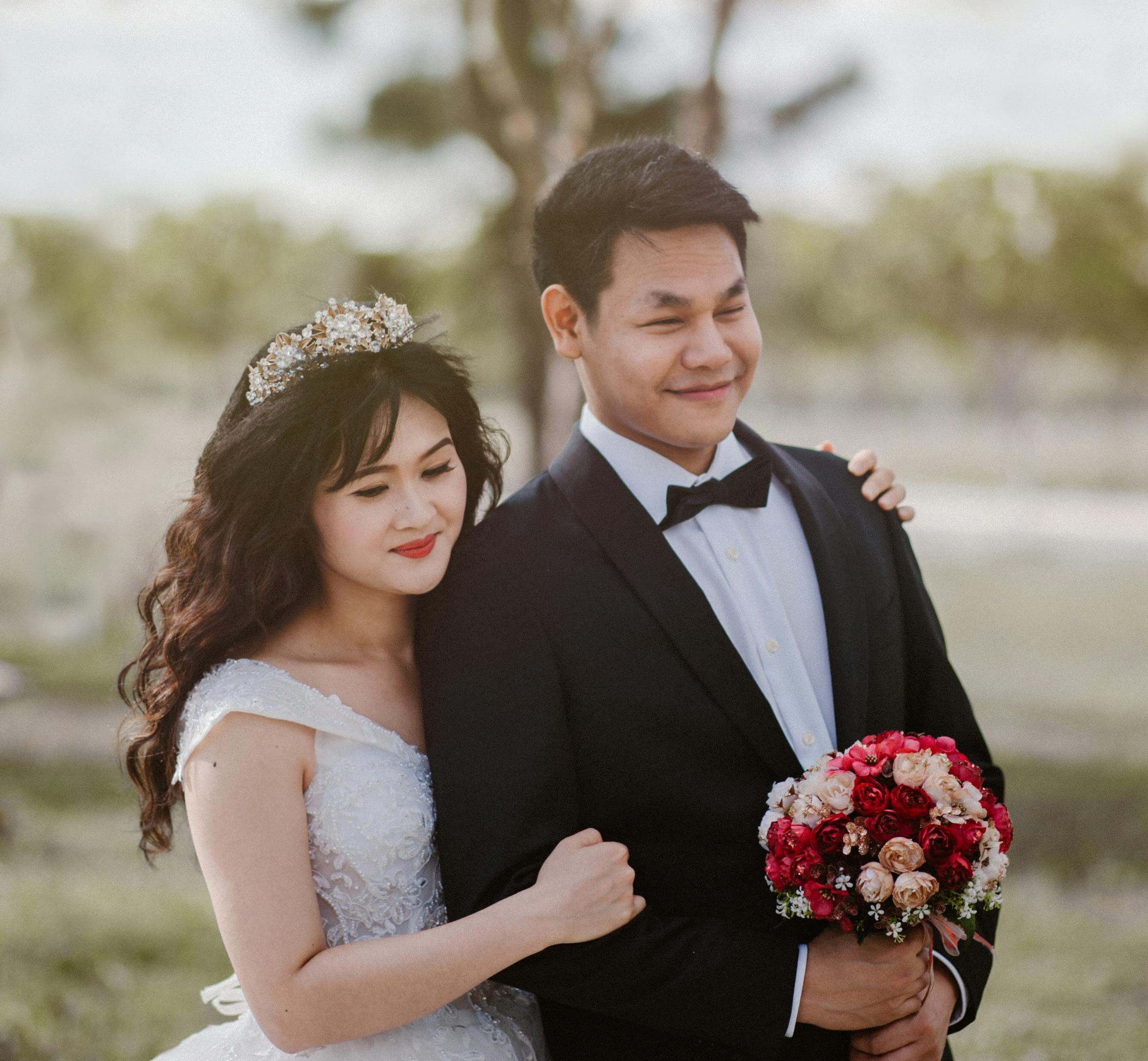 Capturing the joyful moment of a newlywed couple in an outdoor setting.
