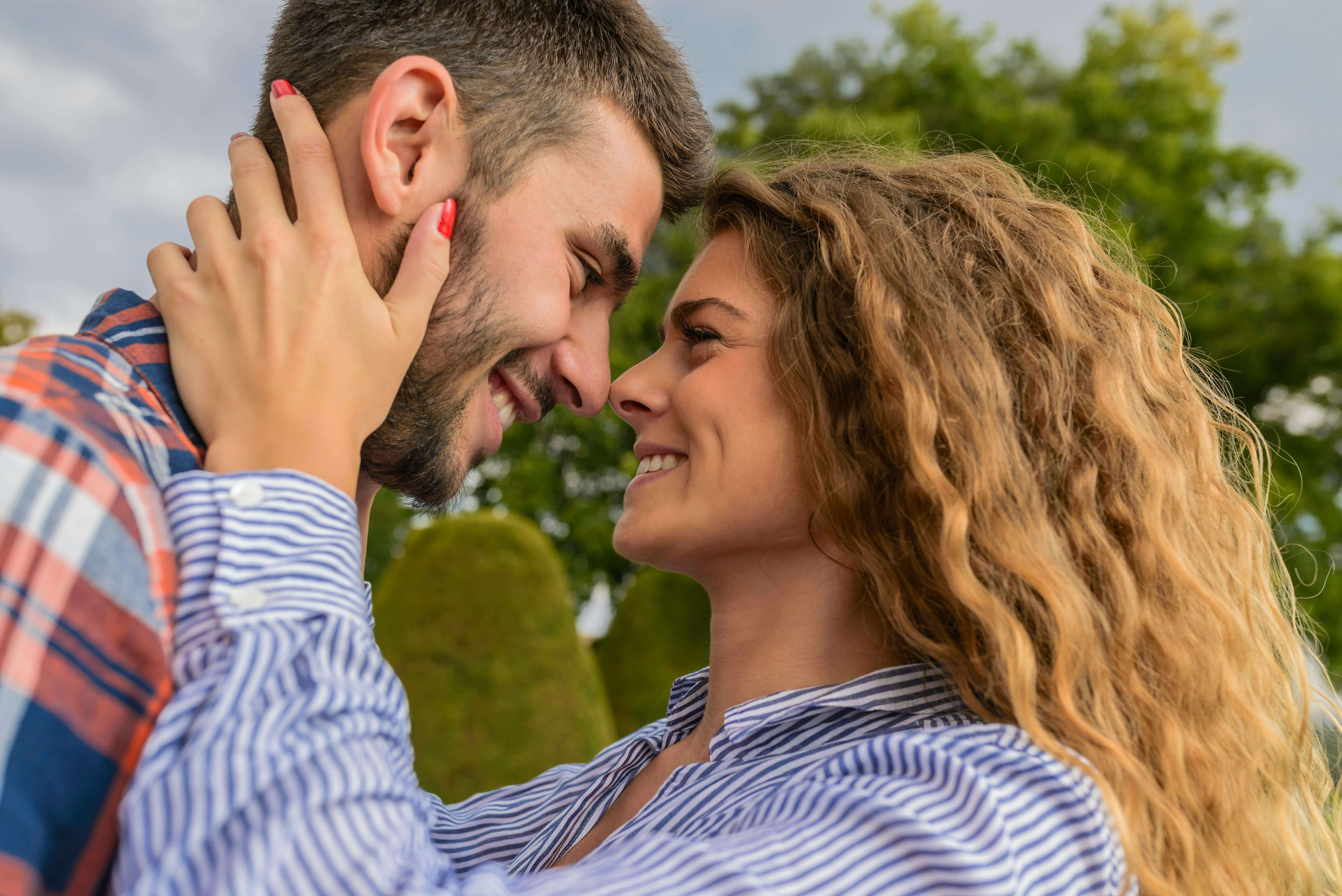 A couple enjoying a joyful moment together outdoors, conveying love and happiness.